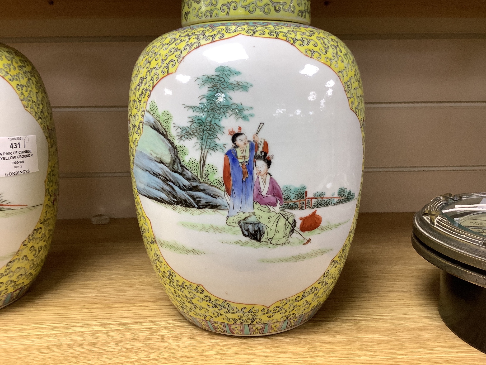 A pair of Chinese yellow ground vases and covers, height 30cm